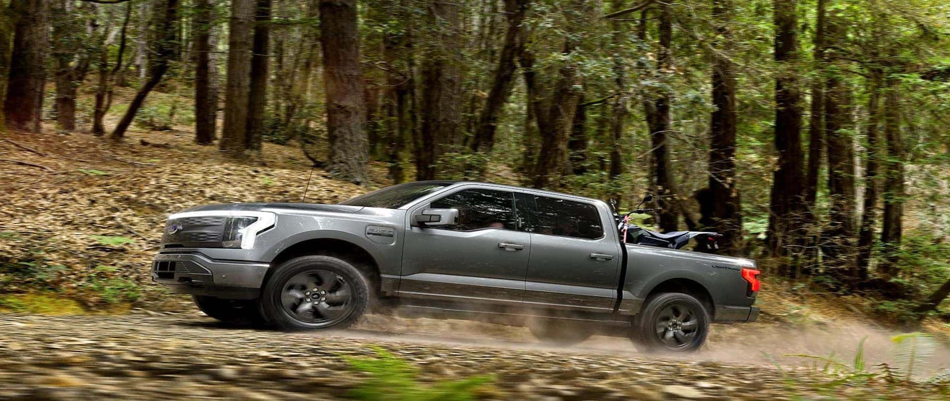 Grey 2022 Ford F-150 Driving on a dirt road