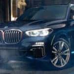 A 2020 BMW X5 at an intersection in a city