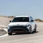 White Hyundai IONIQ 5 driving on a winding road