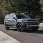 Grey Hyundai Santa Fe parked on pavement near trees