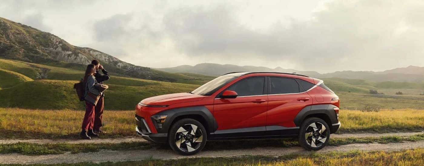 Red 2024 Hyundai Kona driving down a trail.