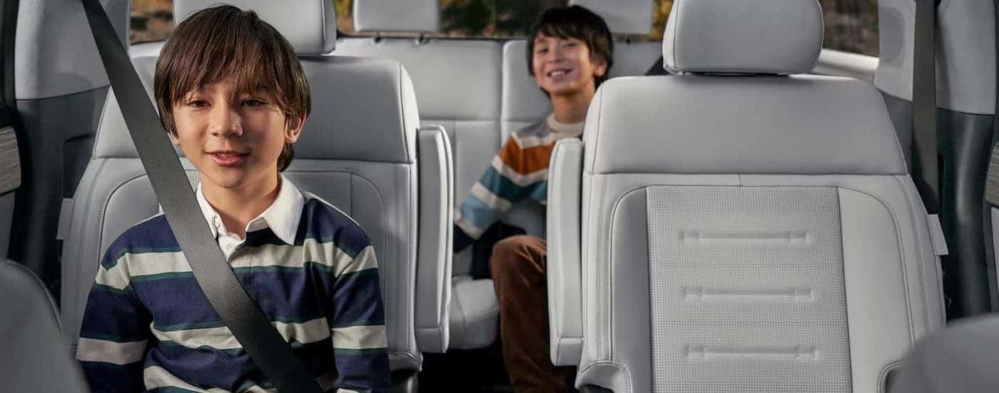 Children sitting in the rear white interior in a 2026 Hyundai Santa Fe.