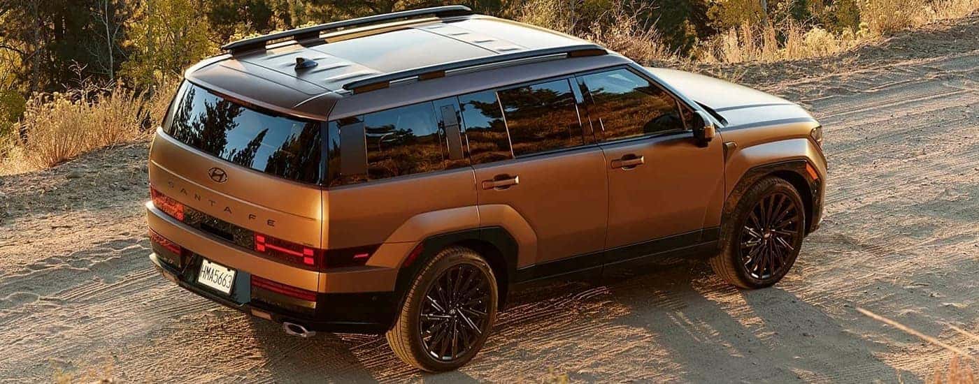 Brown 2025 Hyundai Santa Fe for sale near Huntsville driving on a dirt road