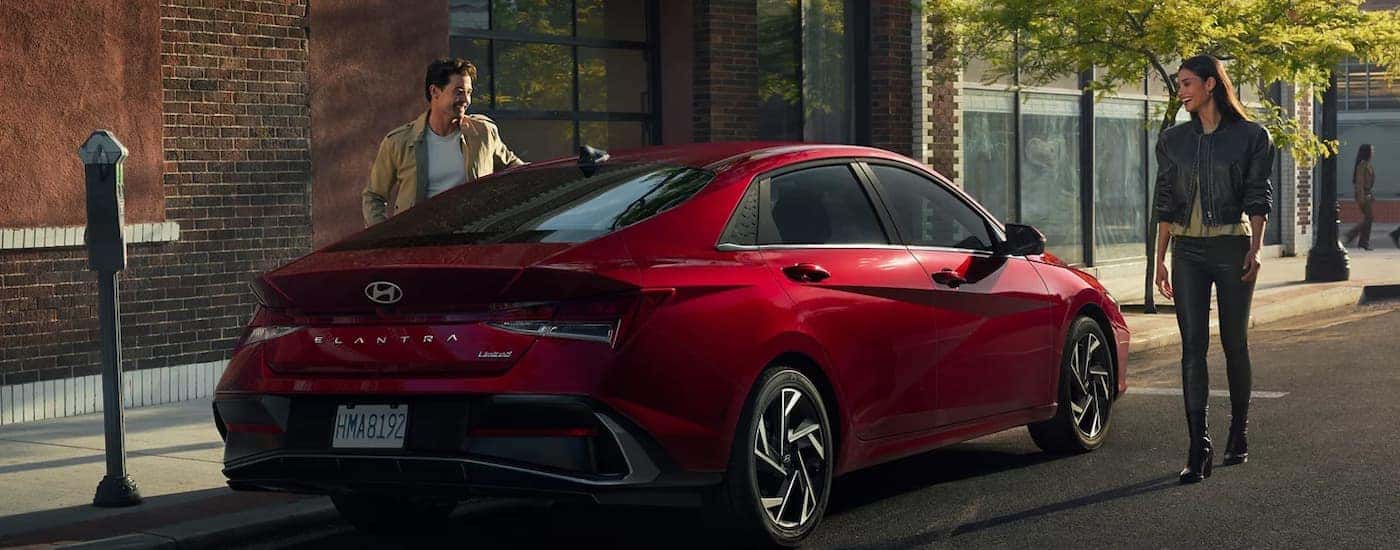 A red 2025 Hyundai Elantra parked on a city street