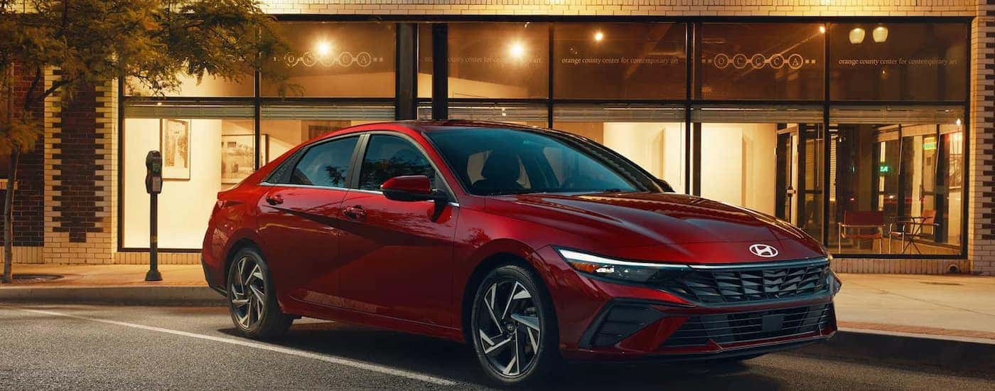 A red 2025 Hyundai Elantra parked in a city