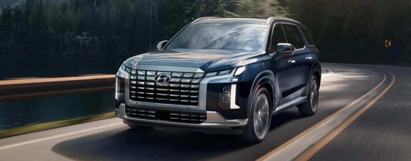 A used 2023 Hyundai Palisade for sale in Montgomery driving down a road