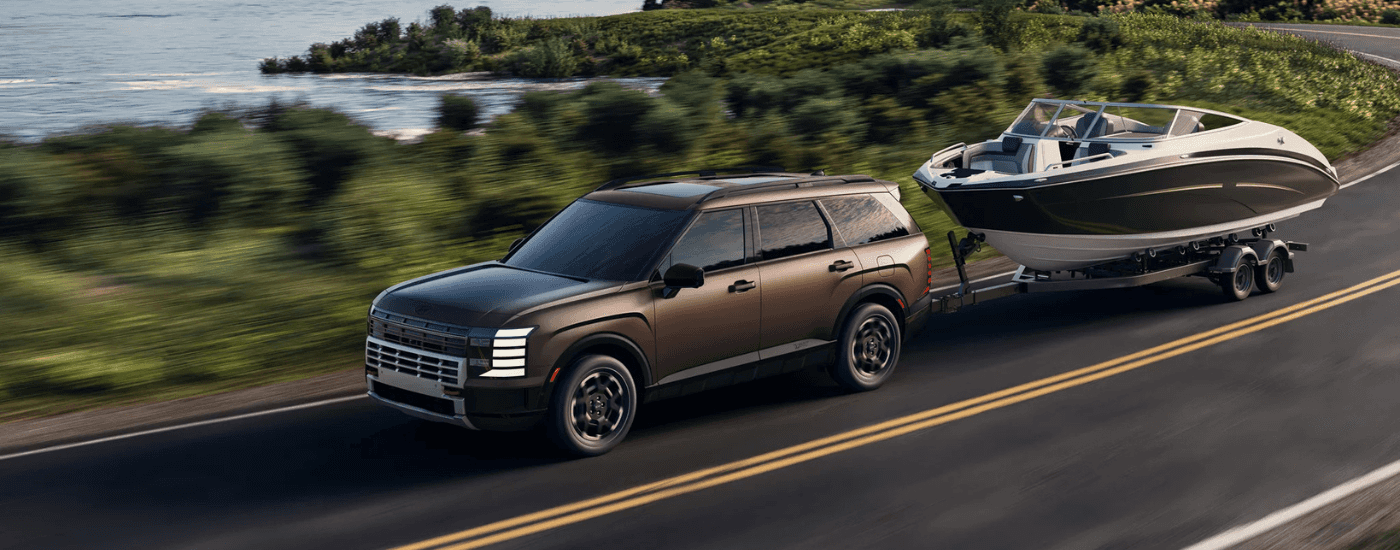 Brown 2026 Hyundai Palisade for sale near Auburn towing a boat