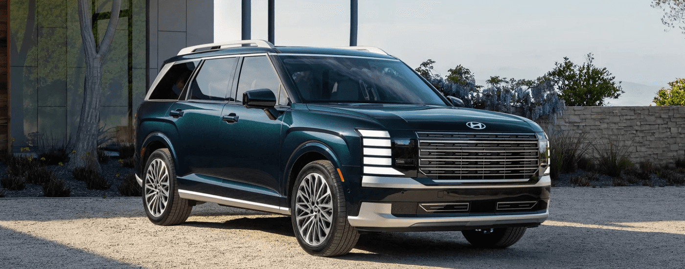 Green 2026 Hyundai Palisade parked at an angle in front of a building