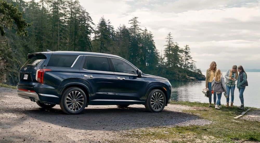 Blue 2023 Hyundai Palisade parked by water
