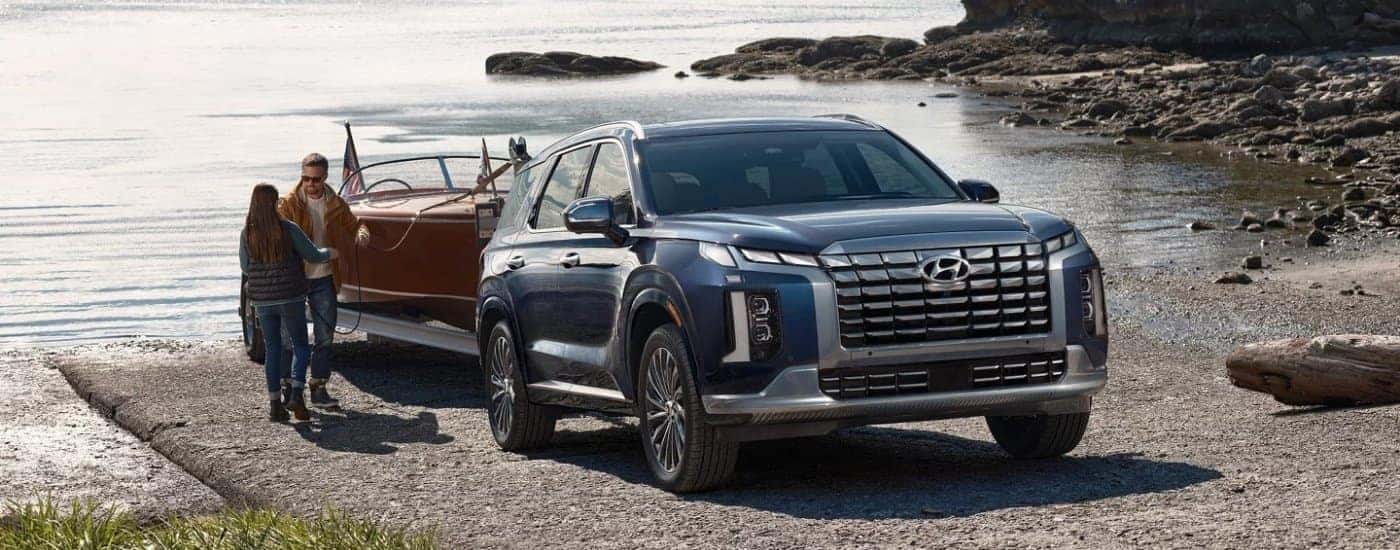 A blue 2024 Hyundai Palisade from the front.
