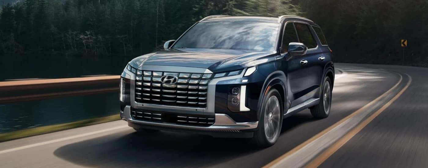 A blue 2024 Hyundai Palisade from the front.
