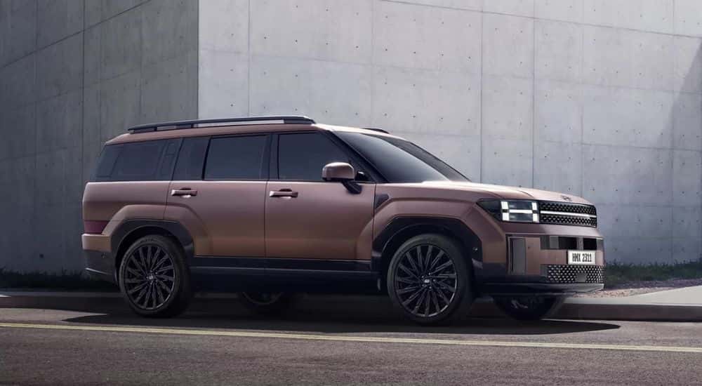 A copper 2024 Hyundai Santa Fe parked in a city.