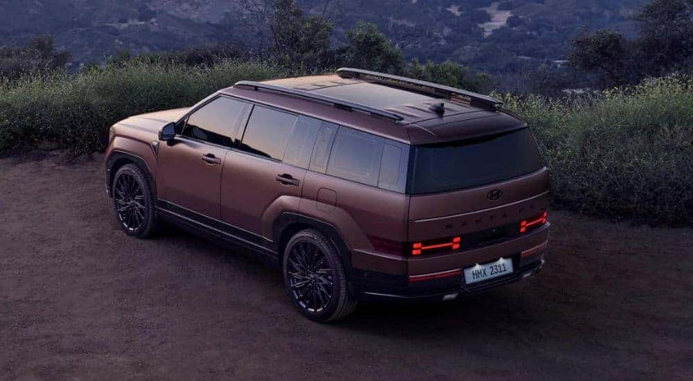 A copper 2024 Hyundai Santa Fe parked on a dirt lot.