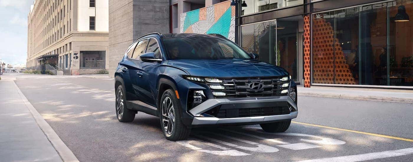 A blue 2026 Hyundai Tucson driving for sale near Birmingham