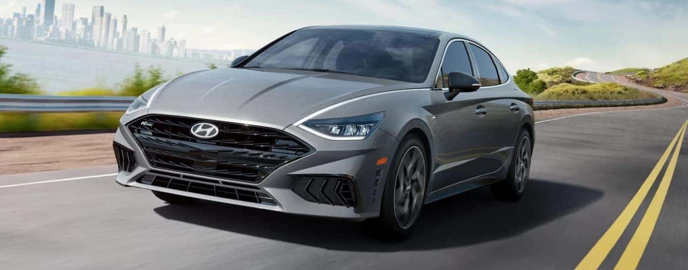 Silver 2022 Hyundai Sonata N-Line driving past a city