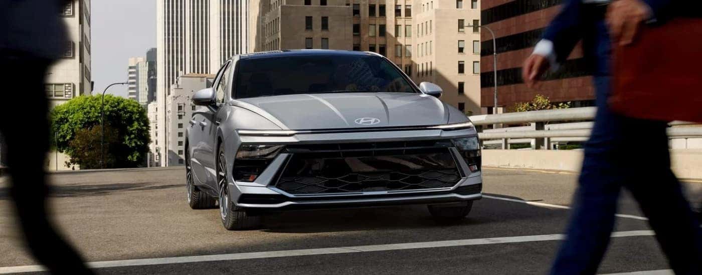 Silver 2026 Hyundai Sonata Hybrid Limited driving on a city street