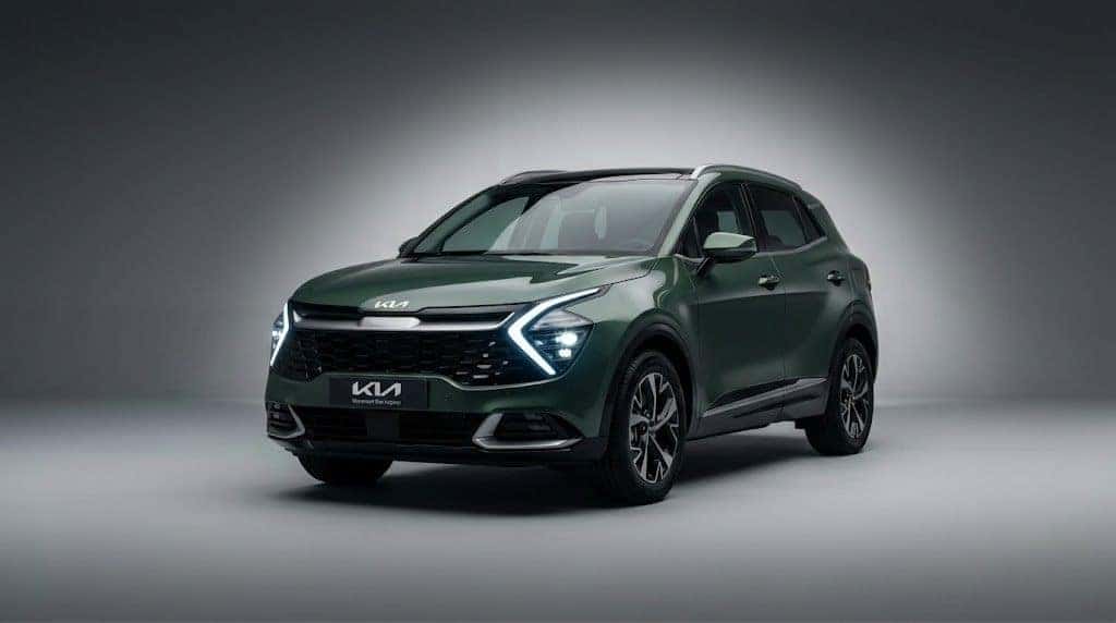 Explore the New Kia Sportage Hybrid A premium studio profile photograph of the latest Kia Sportage Hybrid in Vesta Blue, showcasing its distinct LED lighting signature.
