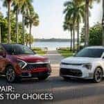 A red 2026 Kia Sportage Hybrid and a white 2026 Kia Niro Hybrid parked alongside a scenic Central Florida lake with palm trees, featuring the U.S. News 2026 Best Adventure Vehicle Awards badge.
