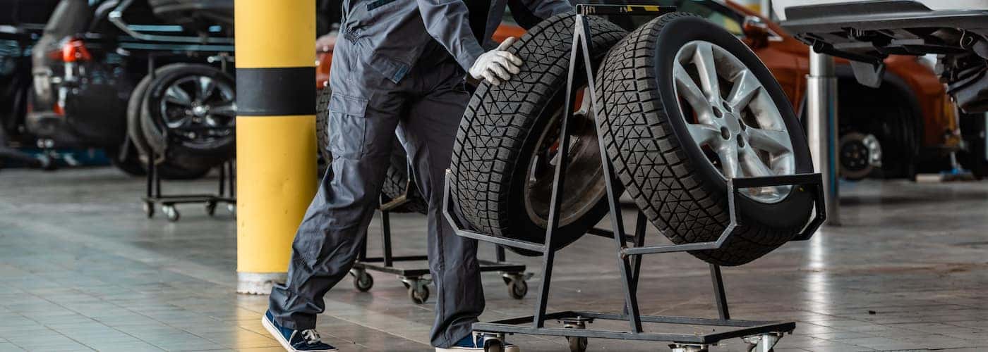 mechanic wheeling over new wheels