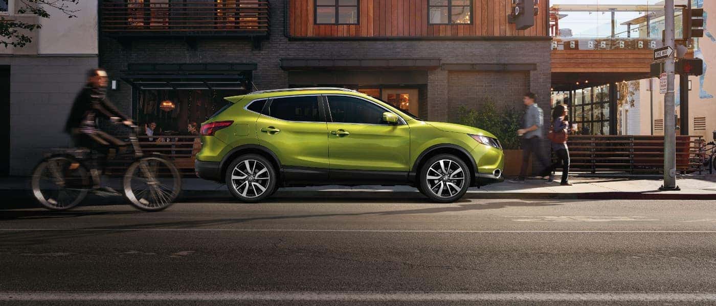 2017 Nissan Rogue A green 2017 Nissan Rogue parked outside of a building