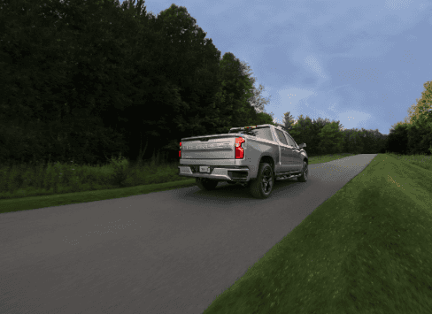 Silverado RST driving down a road, tailgate view