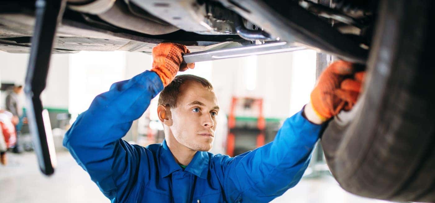 auto mechanic working on suspension