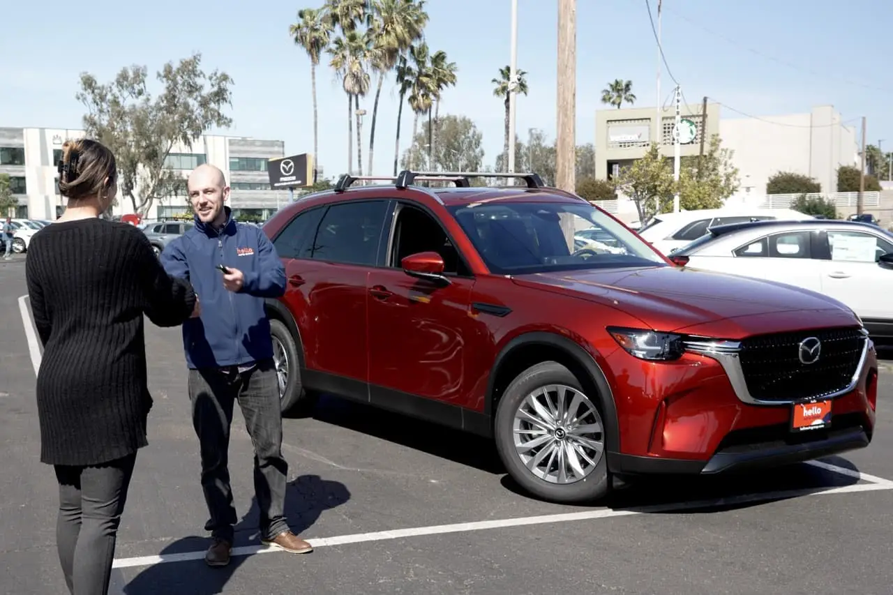 Shaking hands at Hello Mazda of San Diego in front on 2024 Mazda CX-90