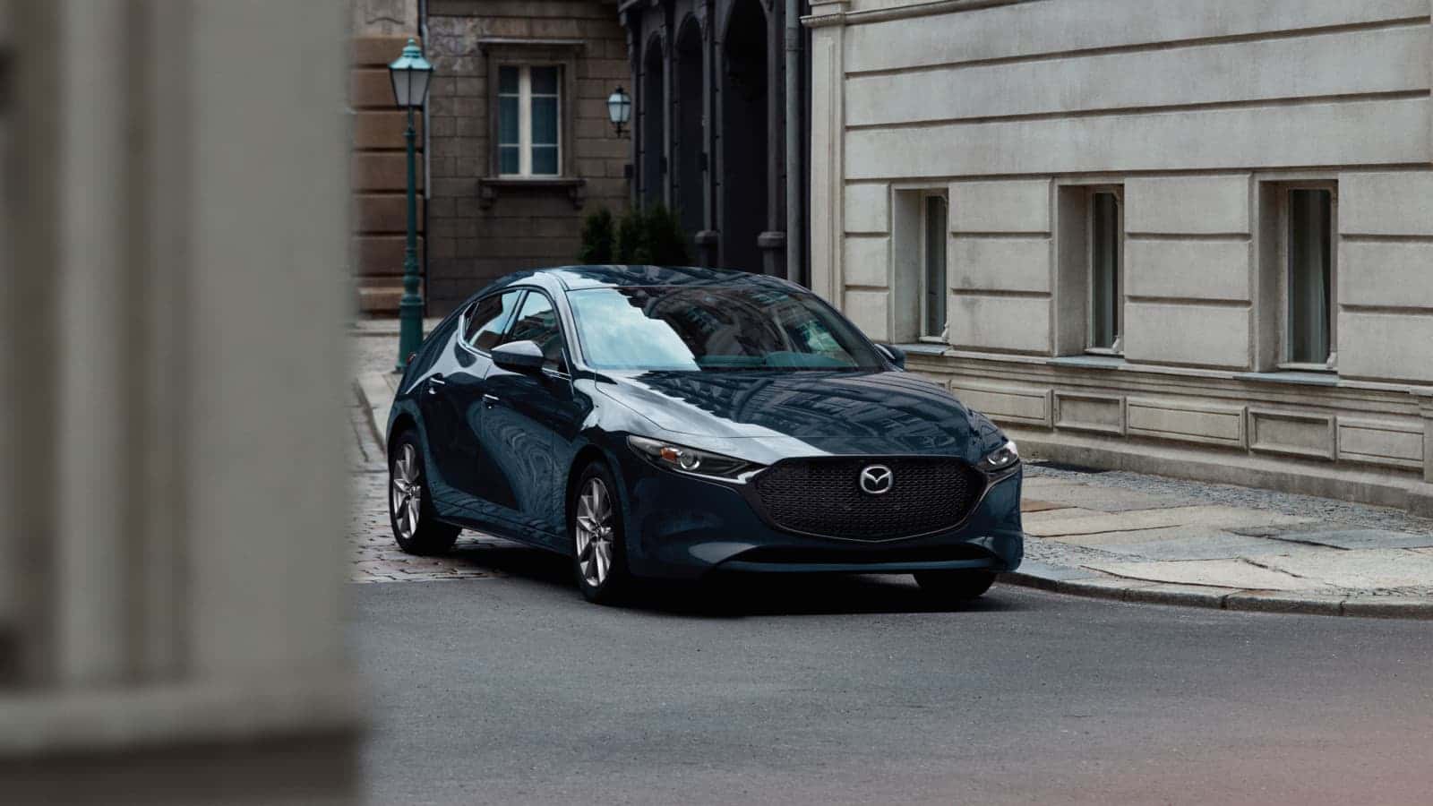 Mazda3 Hatchback parked outside of a building.