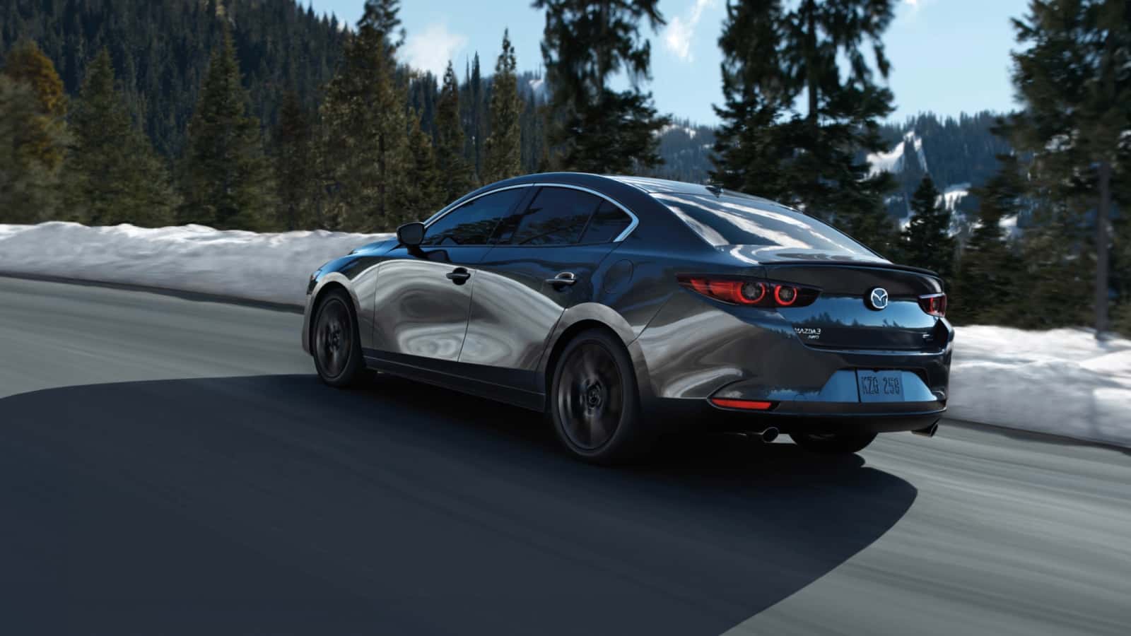 A silver Mazda3 parked outside