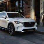 A white PHEV Mazda CX-90 parked