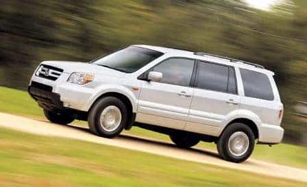 2006 Honda Pilot driving on dirt and grass