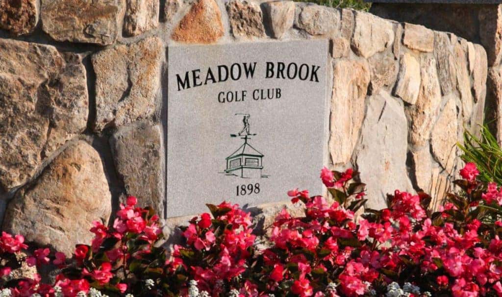 Meadow Brook Golf Club Etched on Stone Sign with Stone background and Flower Bed around sign