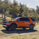 Honda Passport driving down dirt road