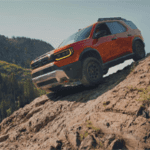 Orange Honda Passport SUV drives down side of mountain