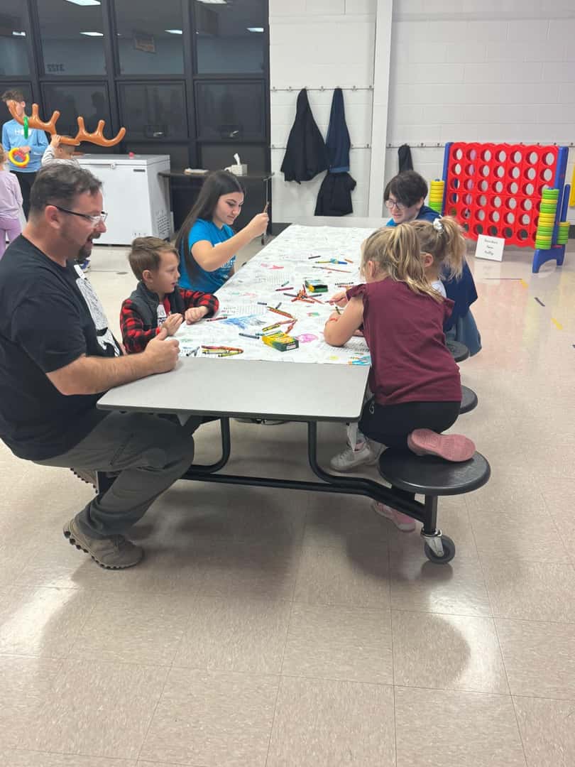 children and adults at cafeteria table