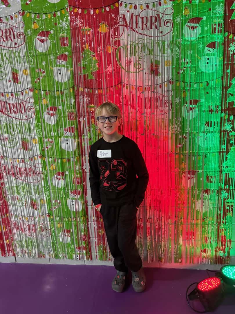 small child in front of christmas backdrop