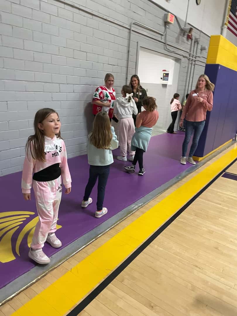group of children and adults in gym