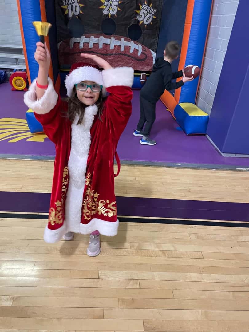 child with red robe and hat