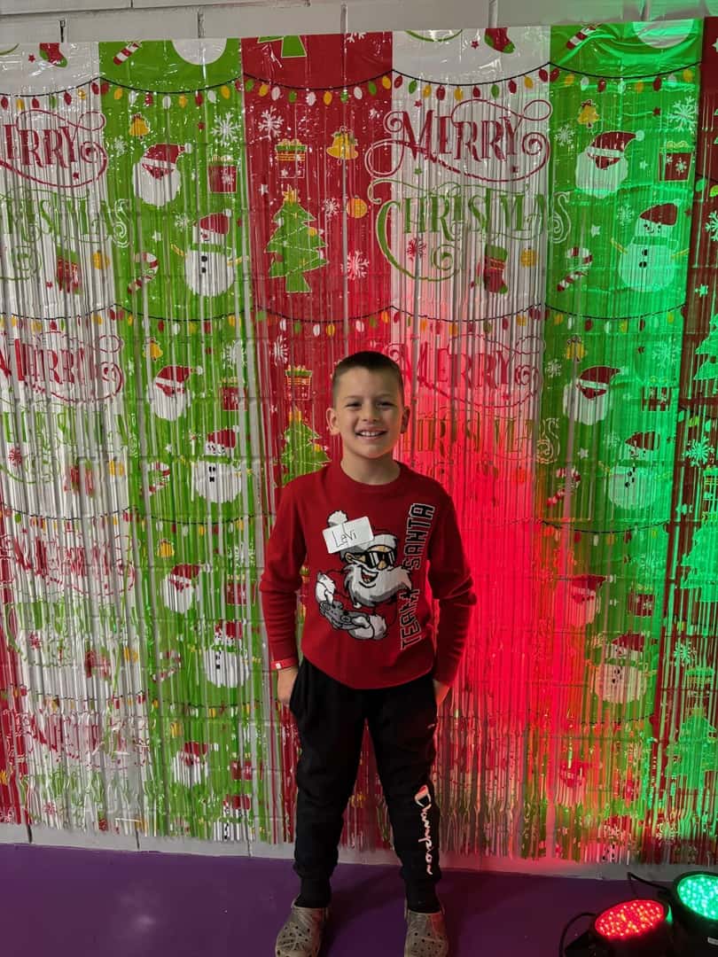 small child in front of christmas backdrop
