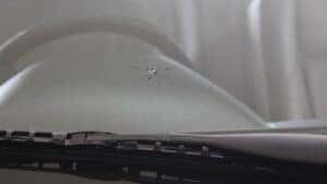 A windshield with a crack caused by a rock