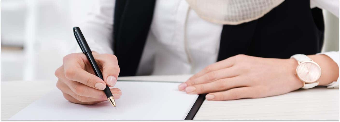 Woman Signing Paperwork