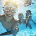 Kids playing underwater in pool
