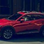 red Mazda cx-3 in a city setting