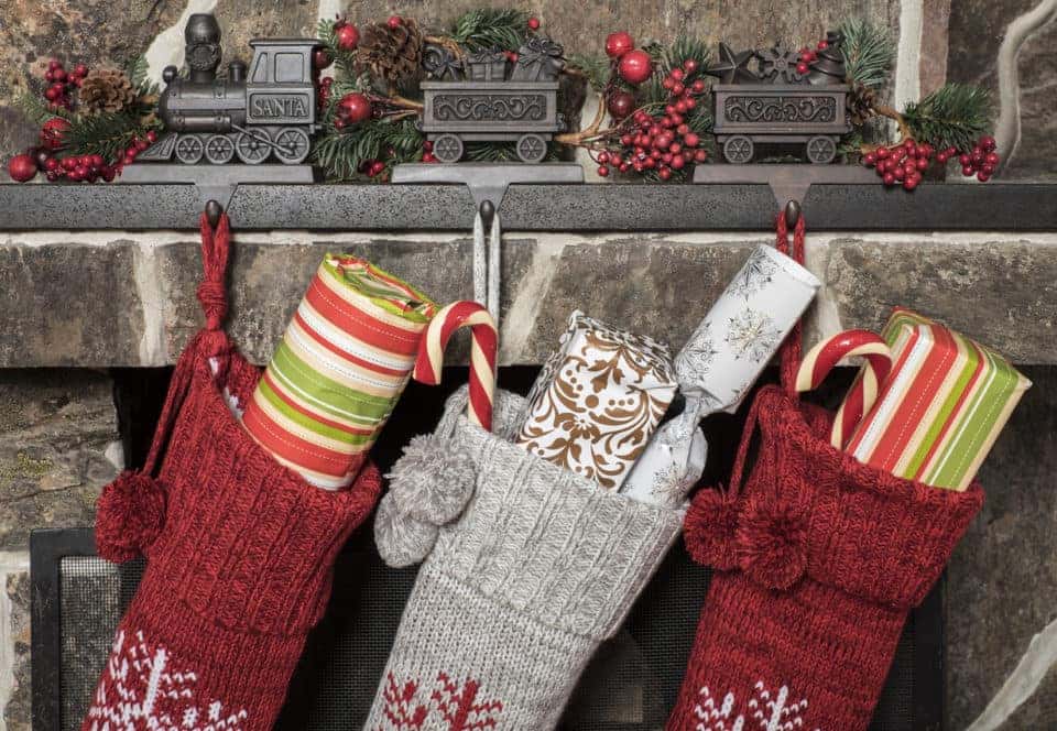 Stuffed stockings hanging on a fireplace on christmas morning