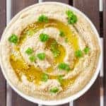 overhead view of a bowl of Baba Ghanoush swirled with olive oil
