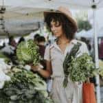 Woman buying fresh kale at farmer's market