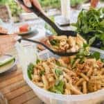 Woman serving pasta salad on a summer day