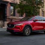 Red 2021 CX-5 on city street in front of brownstone building