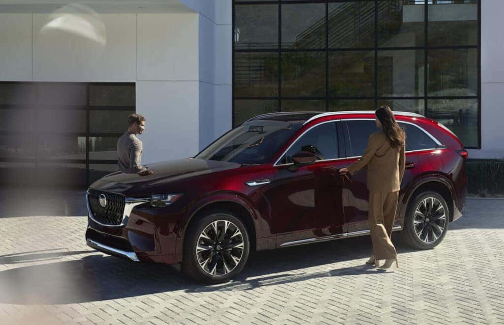 Mazda SUV parked in front of a modern architecture building