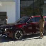 Mazda SUV parked in front of a modern architecture building